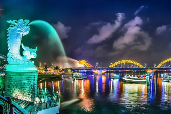 Illuminated Dragon Bridge and dragon fountain over the Han River in Da Nang at night