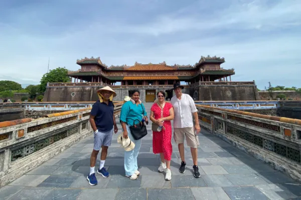 A group of tourists posing on the bridge leading to the gate of Hue Imperial Citadel