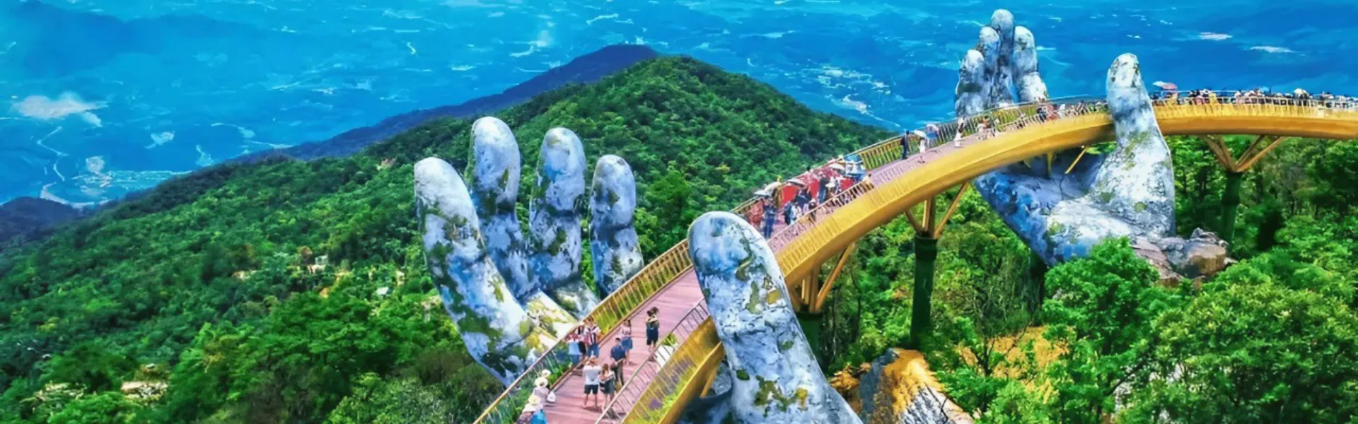Giant stone hands lifting the Golden Bridge above misty mountains at Ba Na Hills, Da Nang
