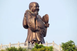 Giant bronze Happy Buddha statue smiling atop Bai Dinh Pagoda, a highlight among Ninh Binh must-see places