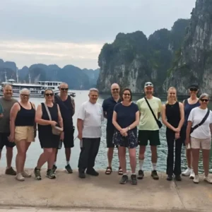Tour group posing dockside before boarding an overnight cruise in Halong Bay, Vietnam