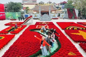 Group posing among colorful fanned incense sticks at Quang Phu Cau Village near Hanoi