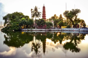 Tran Quoc Pagoda's red tower reflected in West Lake at sunset, Hanoi